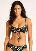 Woman wearing a floral bikini set on a plain background