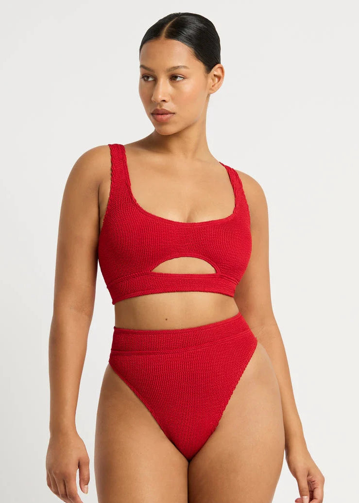 Woman wearing a red bikini set on a white background